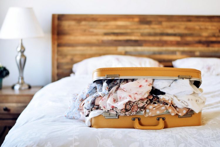 Retro suitcase on a hotel bed