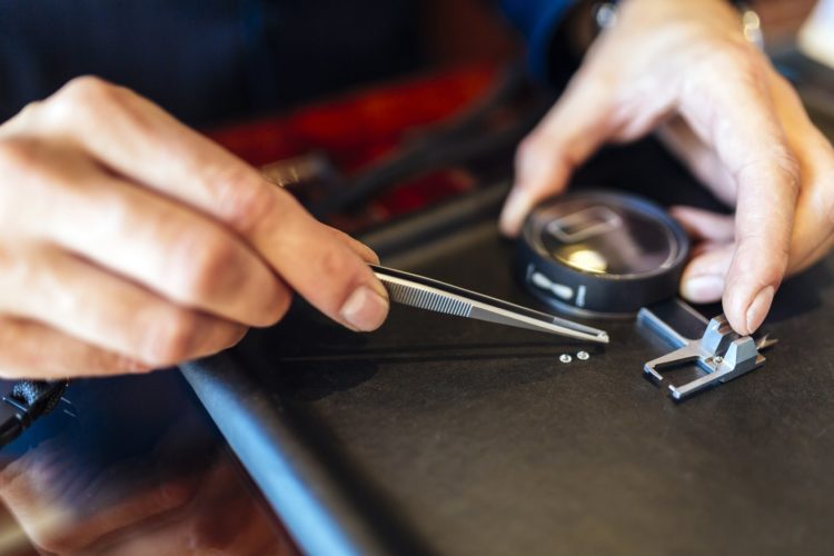 Jeweler checking diamond - measuring gem sizes