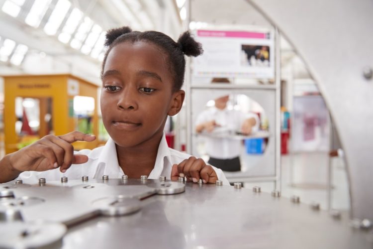 Smart schoolgirl doing a science experiment test