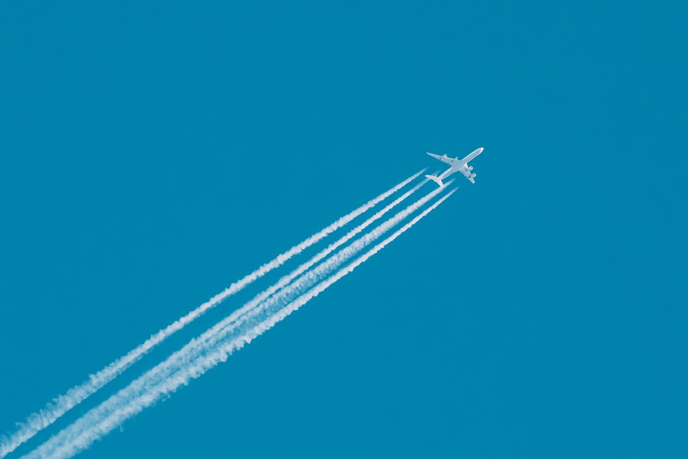 Jet plane flying with white trails from engines