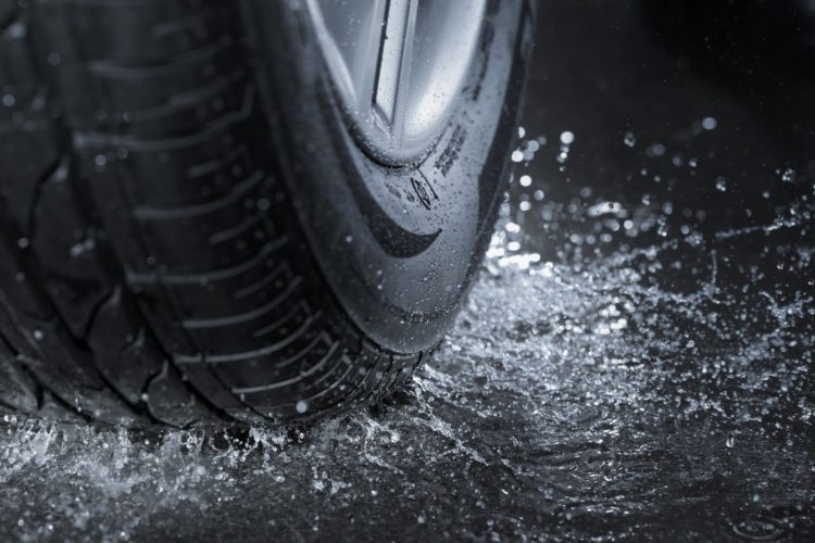 Car tire on a wet road in the rain