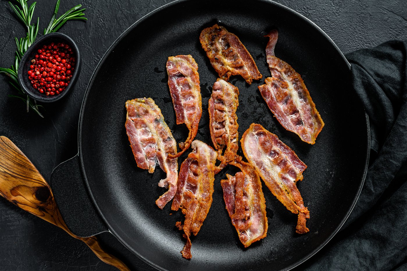 Slices of crispy hot fried cooked bacon