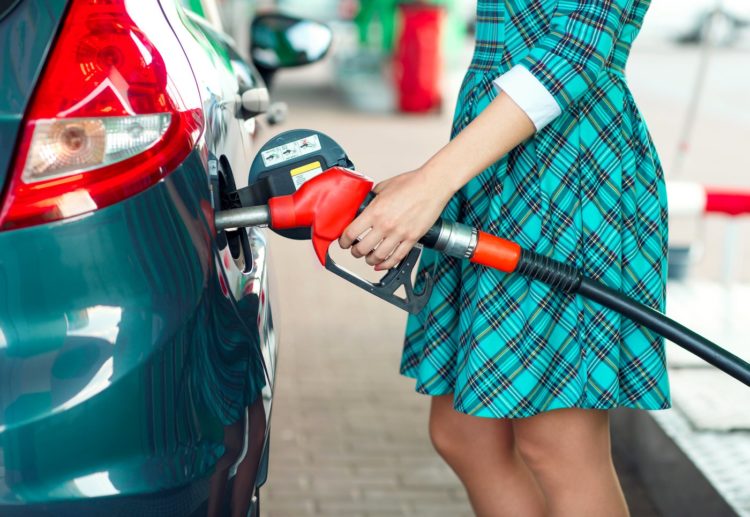 Woman filling car up with gas at self-service station