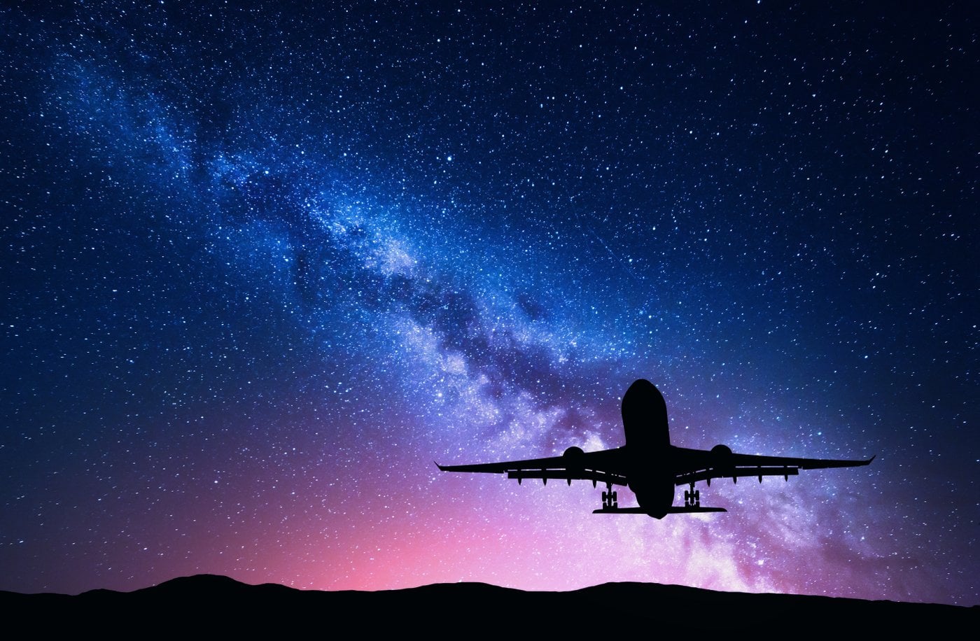 Airplane taking off against a starry background